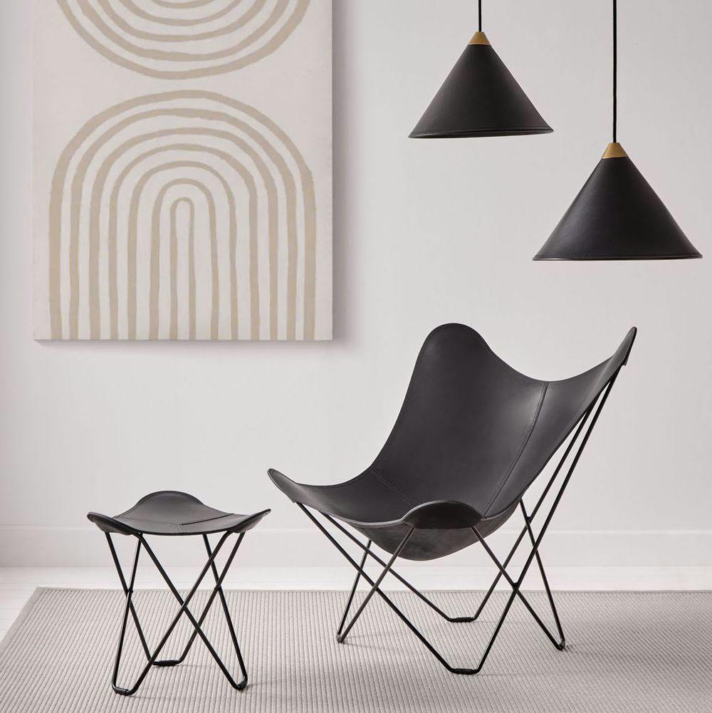 matching set black leather butterfly chair, footrest and cone lamps in minimalistic decor