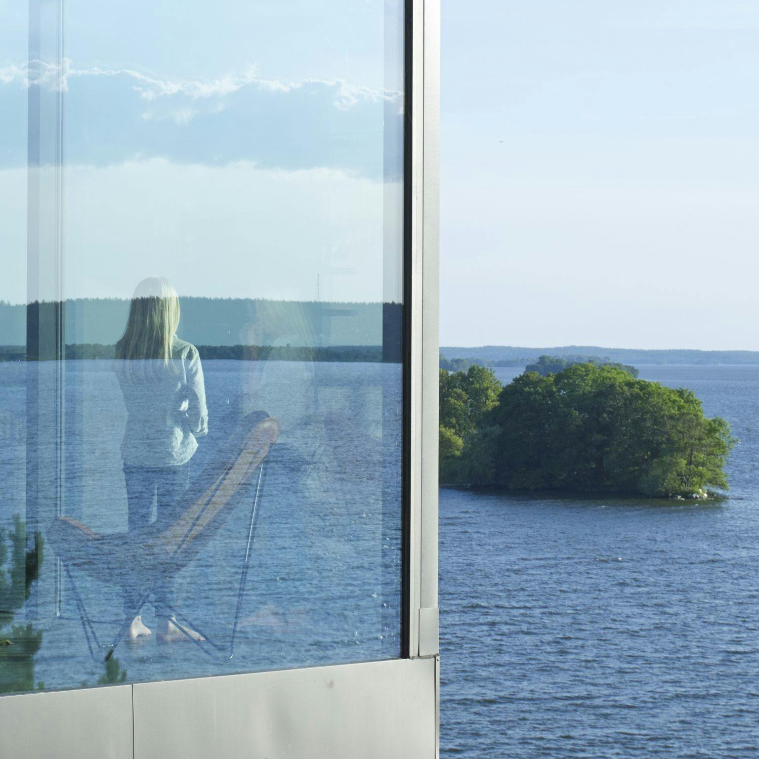 BKF chair in Stockholm Archipelago Sweden modern house with girl looking out the window