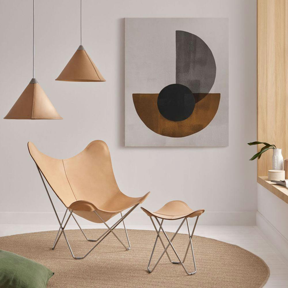 matching set of leather bfk, footrest and cone lamp with minimalistic decor