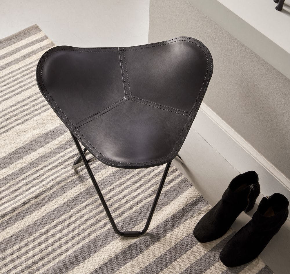 graphite leather stool in entrance with ankle boots