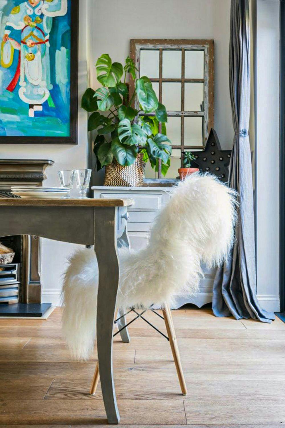 sheepskin throw on dining chair in artsy living room
